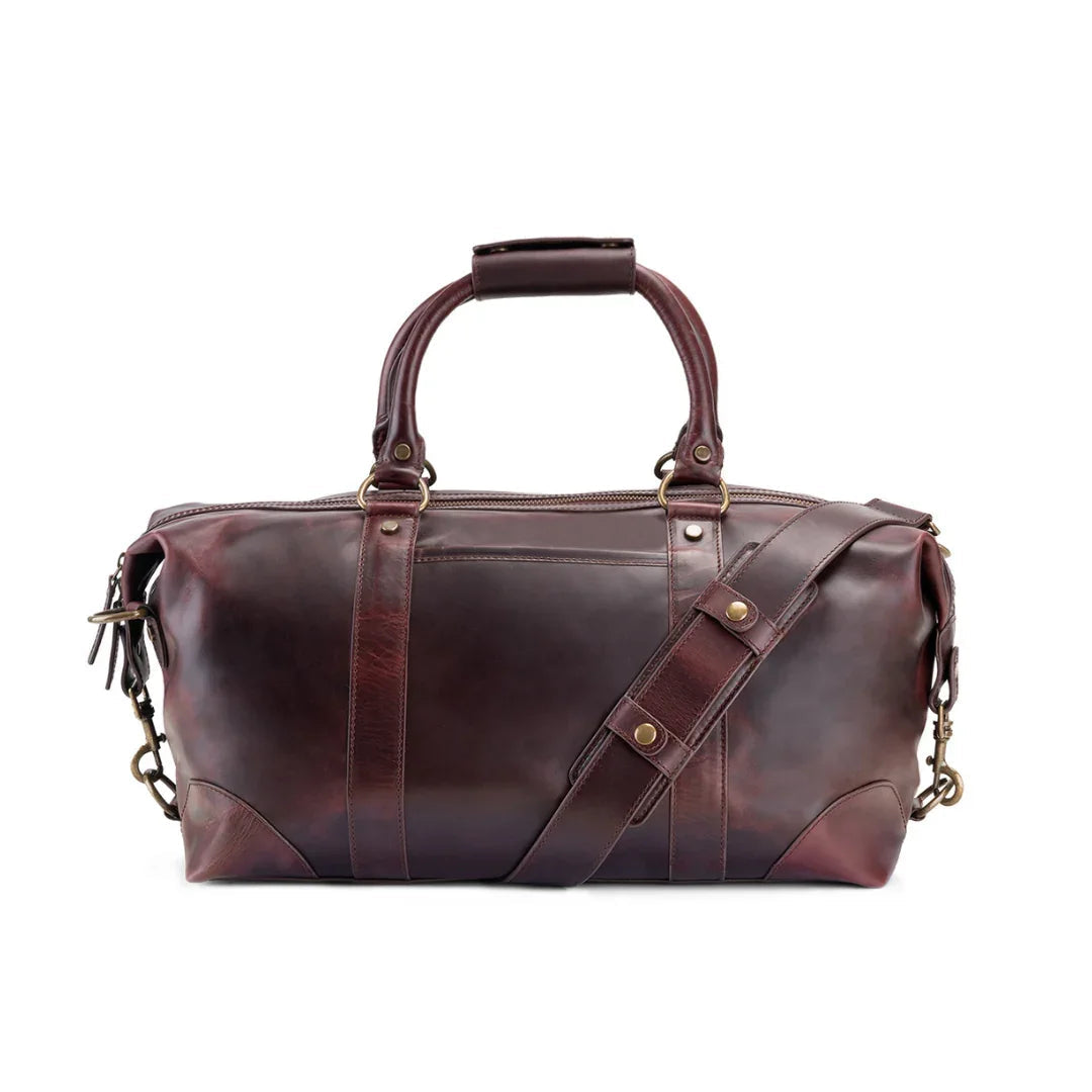 Brown leather duffel bag with gold accents
